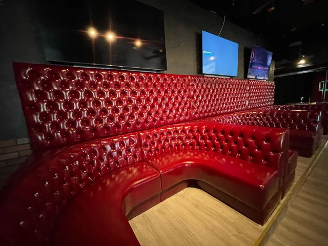 Red diamond-tufted booth seating at Cactus Jacson