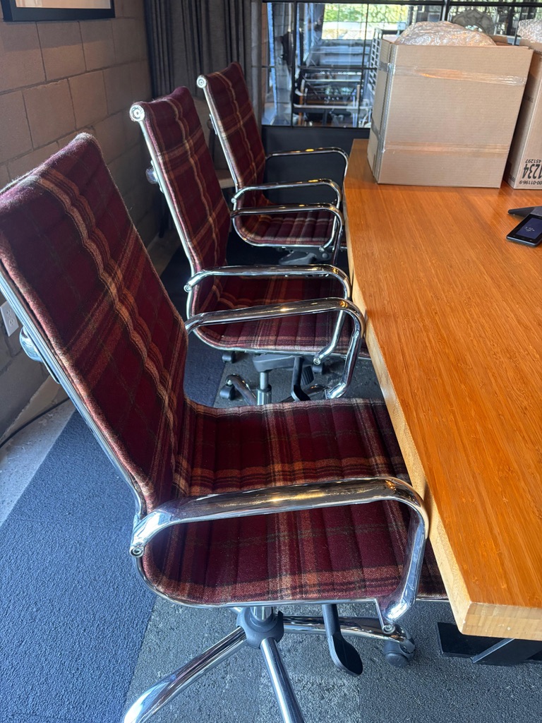 Burgundy plaid upholstered conference chairs with chrome frames at the Fox Restaurant Concepts main office in Phoenix