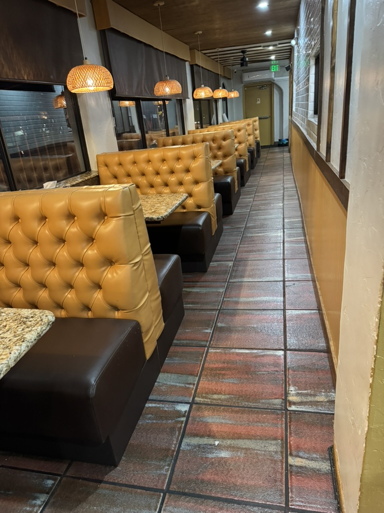 gold tufted booth row — Installed restaurant seating photograph