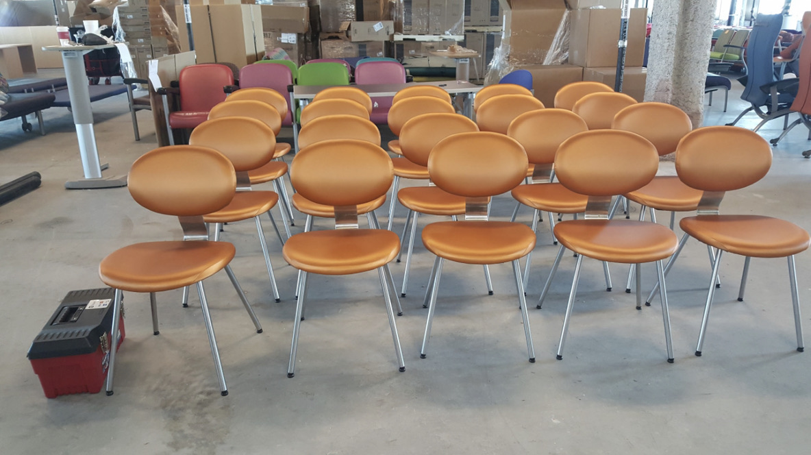 orange upholstered chair rows — chair photograph in staging or work area; not confirmed hospital installation