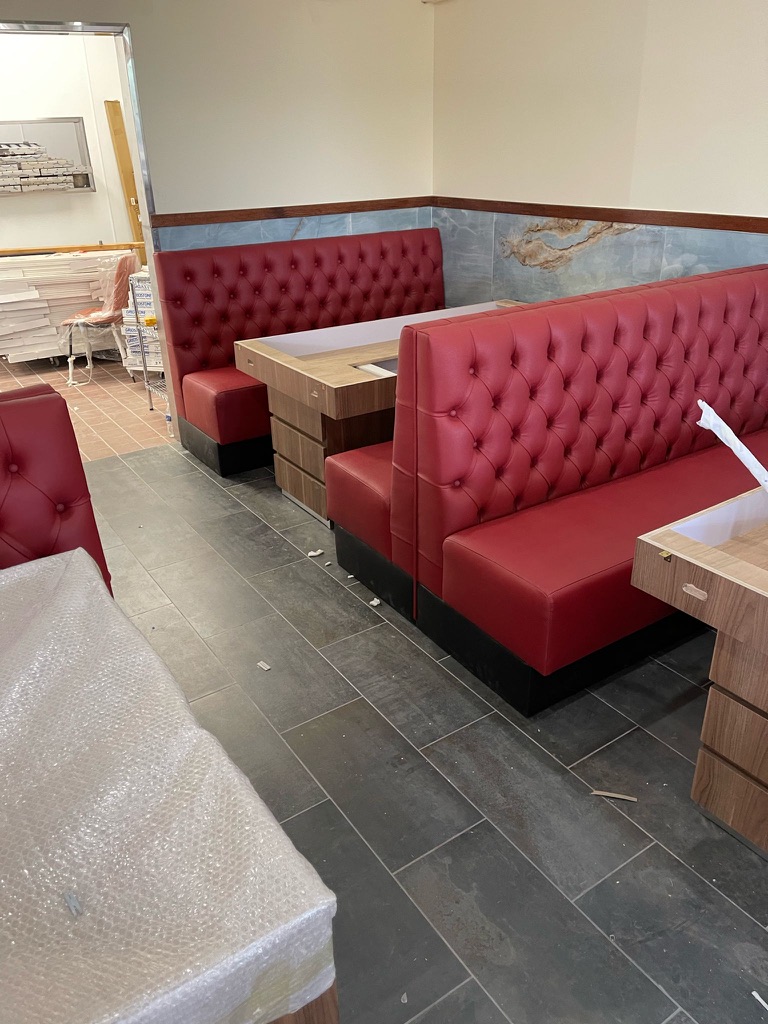 Red tufted booths and hot-pot tables