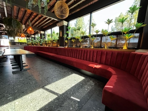 Red vertical-channel banquette seating around the covered patio at Tataki Sushi in Tempe