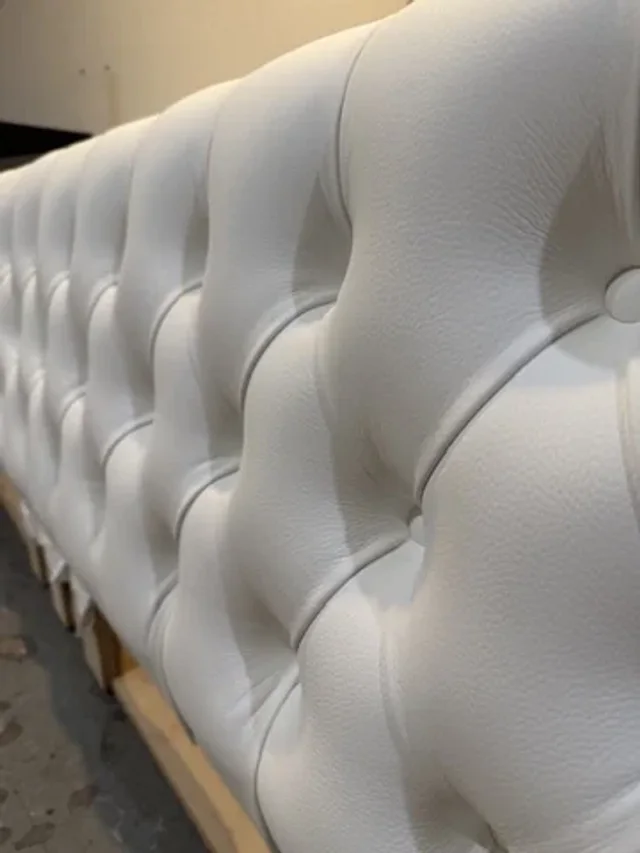 Close-up of white button tufting and upholstery texture