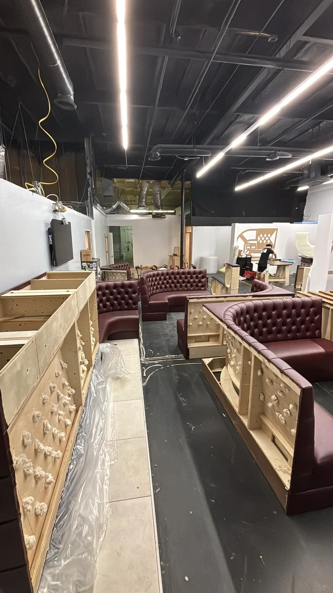 Curved booths in the workshop with unfinished backs visible