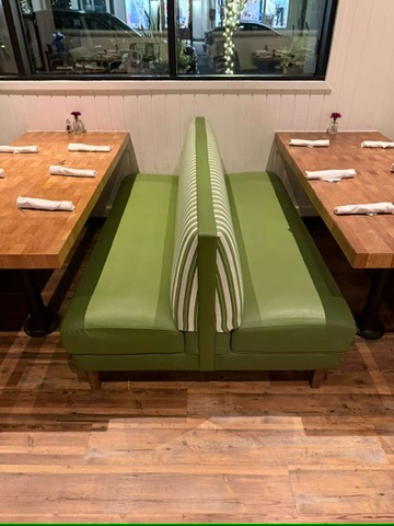 Green reupholstered booth seats with striped backs at Zinburger Scottsdale Quarter, with the original damaged seat documented in the gallery