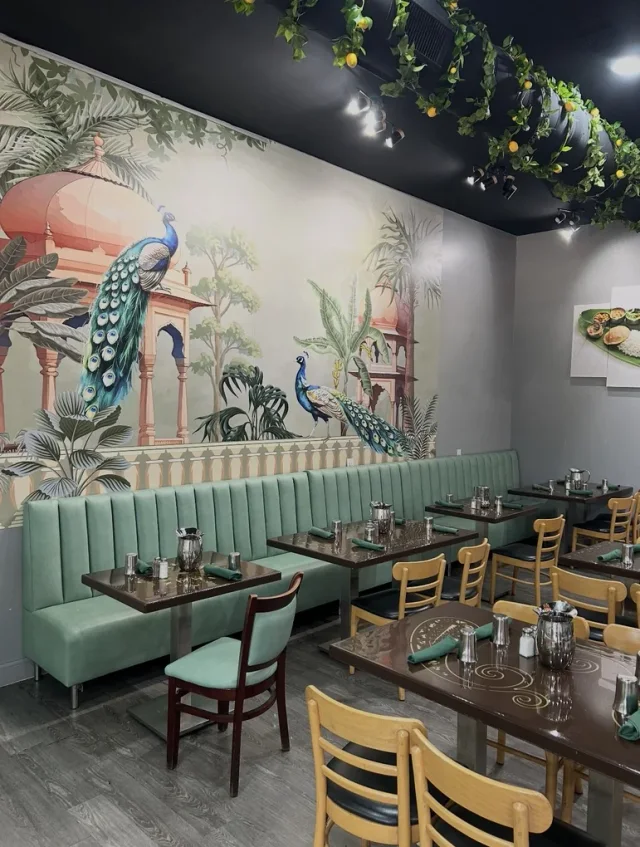 Mint channel seating beneath a peacock mural